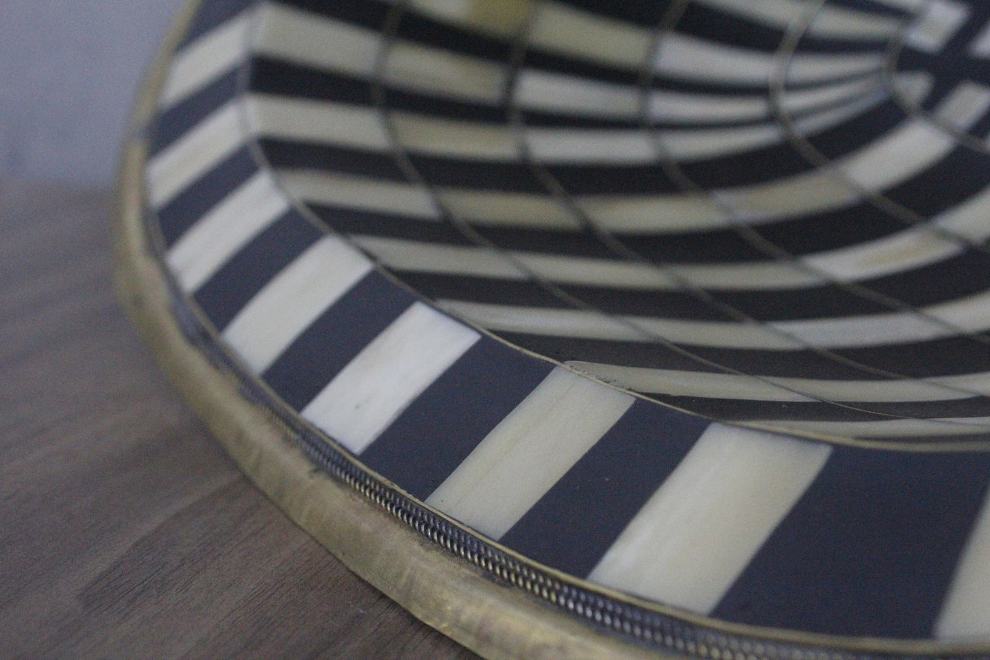 Stunning black and white oval drop-in sink featuring a single hole, resilient brass, and resin basin.