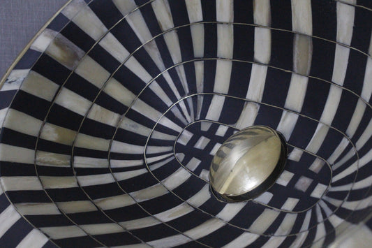 Stunning black and white oval drop-in sink featuring a single hole, resilient brass, and resin basin.