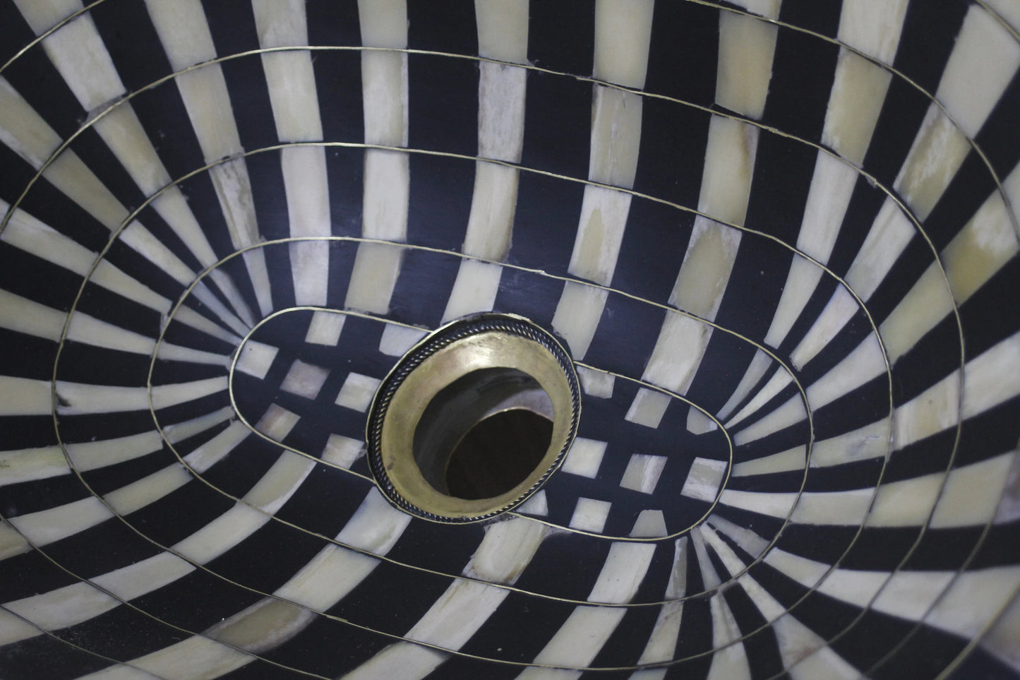 Stunning black and white oval drop-in sink featuring a single hole, resilient brass, and resin basin.