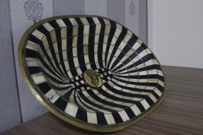 Stunning black and white oval drop-in sink featuring a single hole, resilient brass, and resin basin.